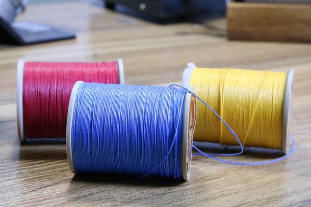 3 coloured threads on bobins